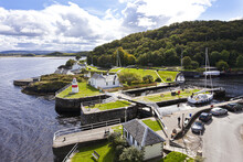 A Yacht Using The Sea Lock To Enter The Canal Basin On The Crinan Canal At Crinan, Knapdale, Argyll & Bute, Scotland UK