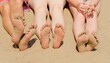 © Kryuchka Yaroslav - Feet of a family relaxing on a sandy beach
