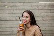 © jozzeppe777 - woman holding takeaway cup of smoothie