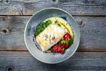 Modern Style Traditional Fried Skrei Cod Fish Filet With Mashed Potato Cream And Coriander Lime Relish Served As Top View On Nordic Design Plate With Copy Space