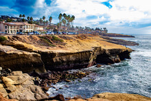 Beautiful Partly Cloudy Sky With The Waves Crashing On The Rocks At Sunset Cliffs In San Diego, California, USA