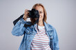 © evafesenuk - Mature woman professional photographer takes a picture with a digital camera.