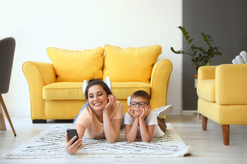 Sticker - Young woman and her little son taking selfie at home