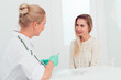 © shapovalphoto - Young woman beautician talking with a young blond woman about new facial skin care procedures, Professional cosmetician examining face skin