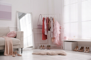 Poster - Modern dressing room interior with clothing rack and mirror