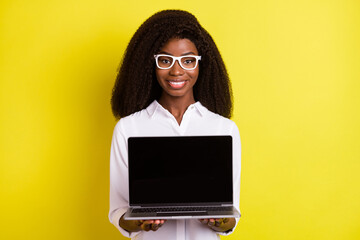 Poster - Photo of optimistic young agent lady show laptop wear spectacles white shirt isolated on vivid yellow color background