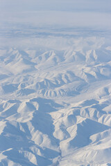 Sticker - Aerial view of snow-capped mountains. Winter snowy mountain landscape. Travel to the far north of Russia. Kolyma Mountains, Magadan Region, Siberia, Russian Far East. Great for the background.