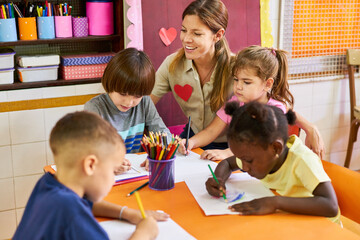 childminder and multicultural children while painting