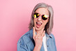 © deagreez - Photo of crazy old happy excited old woman make fingers rock sign wear sunglass isolated on pink color background
