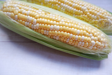 Sweet corns on white wooden table background. healthy food, natural vegetables, fresh vegetables.