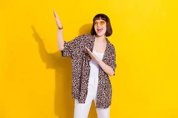 Wall Mural - Photo of joyful hipster lady dance look empty space wear eyewear leopard shirt isolated on vivid yellow color background