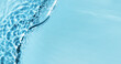 Defocused blue liquid colored clear water surface texture with splashes bubbles with copy space. Water waves in sunlight background. Trendy summer nature banner. 
