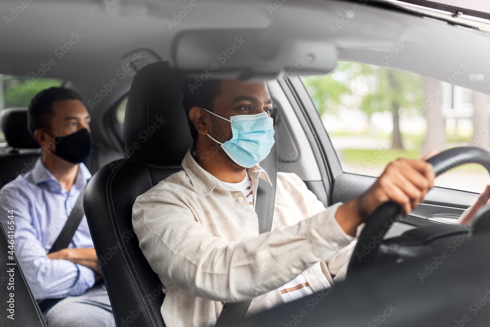 transportation, health and people concept - indian male taxi driver driving car with passenger wearing face protective medical mask for protection from virus disease - obrazy, fototapety, plakaty 