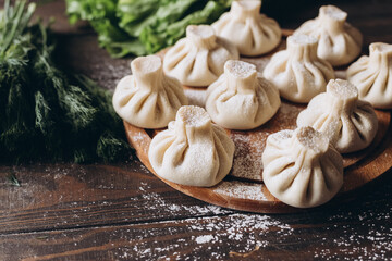 Poster - Georgian homemade dumpling or khinkali on cutting wooden board.