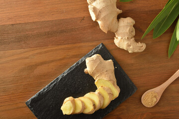 Ginger sliced on slate plate and spoon with powder top