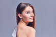© Olena Apetroaiei - Beautiful young woman with clean perfect skin. Portrait of beauty model with natural nude makeup. Spa, skin care and wellness. Close up, gray background, copyspace.