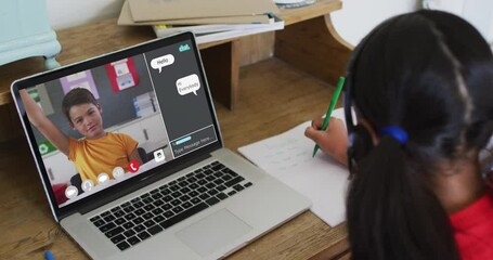 Canvas Print - Schoolgirl using laptop for online lesson at home, with her colleague and web chat on screen