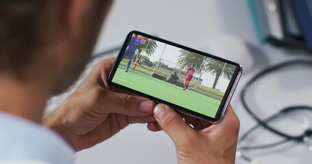 Wall Mural - Composite of male doctor watching hockey match on smartphone