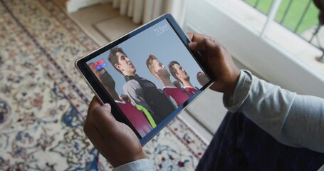 Sticker - Composite of man sitting at home, watching sports event on tablet