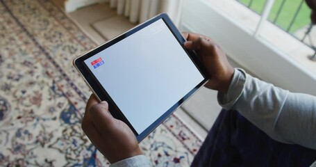 Sticker - Composite of man sitting at home watching football match on tablet