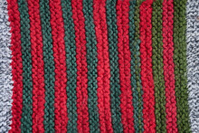 Colored Knitted Blanket Made Of Wool Yarn In Stripes And Rectangles For Home Design.