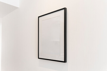 home decoration, empty black frame, poster, white canvas, mock up on a white wall, living room, temp