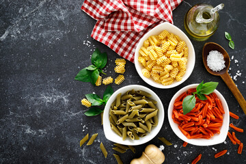 Poster - Pasta. Various kinds of uncooked pasta and noodles over stone background, top view with copy space for text. Italian food culinary concept. Collection of different raw pasta on cooking table