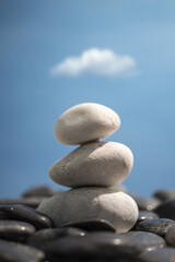 Sticker - Vertical shot of stones on a blurred sky background