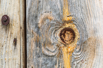 Knot in weathered wood on an old barn.