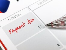 Reminder Concept Of Payment. Close Up Text Payment Due Written On Calendar With A Pen. Selective Focus.