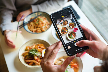 close up of woman with smartphone taking picture of dessert at restaurant