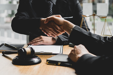 Businessman shaking hands to seal a deal Judges male lawyers Consultation legal services Consulting in regard to the various contracts to plan the case in court.