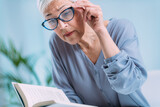 Fototapeta  - Glaucoma. Senior Woman a Reading Book, Having Ocular Tension.