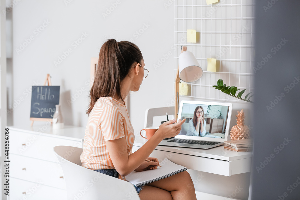Female student studying online at home