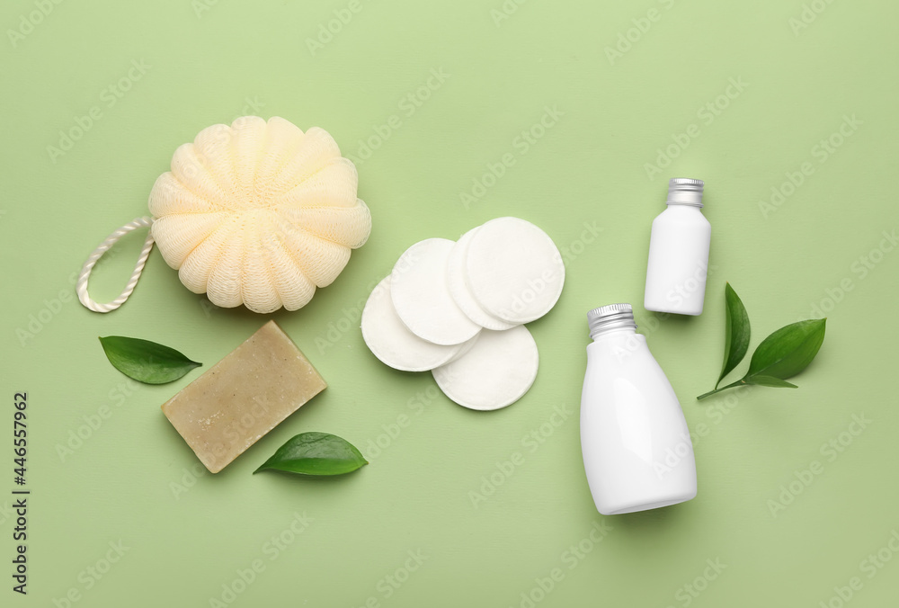Cotton pads and cosmetic products on color background