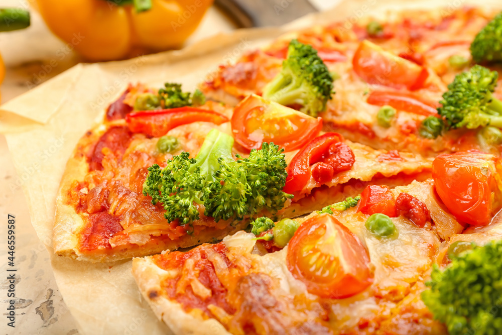 Parchment with tasty vegetarian pizza on table, closeup
