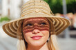 © ADDICTIVE STOCK - Woman in straw hat on sunny day in city