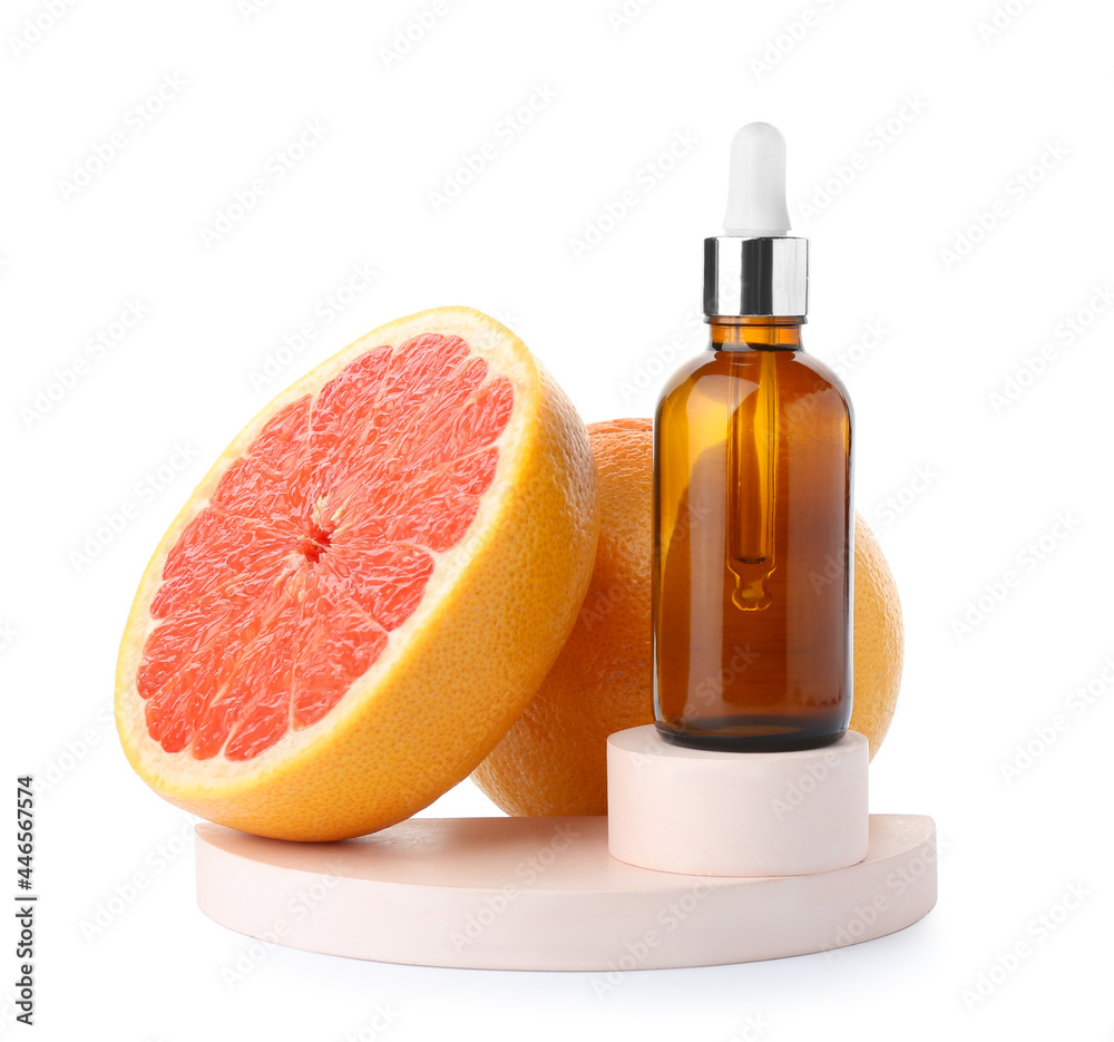 Bottle of essential oil and grapefruits on white background - obrazy, fototapety, plakaty 