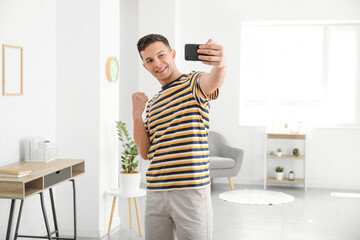 Wall Mural - Young man taking selfie at home