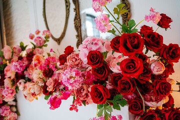 Decoration of the fireplace with artificial red flowers