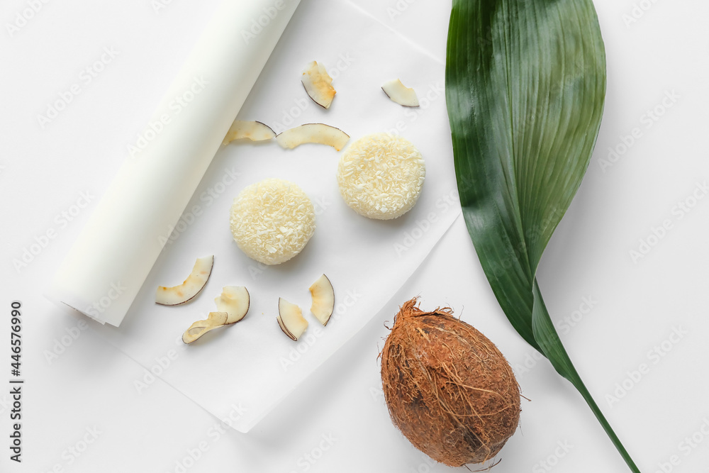 Parchment with tasty coconut mochi on white background