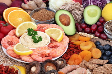 Immune boosting healthy flexitarian diet food high in antioxidants, protein, omega 3, vitamins, minerals, fibre. Seafood, vegetables, fruit, cereals, pasta, spice, seeds and supplement powder.