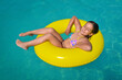 © SuperCoolPhotography - Real adorable girl relaxing in swimming pool