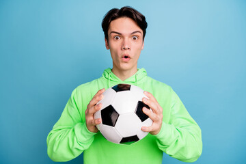 Sticker - Photo of excited crazy football player guy hold ball open mouth wear green sweatshirt isolated blue color background