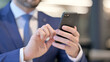 © stockbakers - Close up of Hands of Businessman using Smartphone