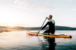 © ADDICTIVE STOCK - Man on paddle board floating on lake
