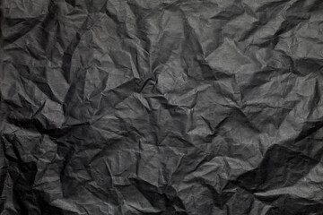 Wall Mural - Crumpled black paper texture background.