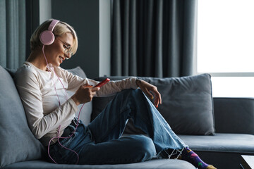 Canvas Print - Happy girl listening to music or having a video chat