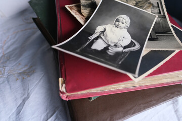 old photo albums lie on a white mint tablecloth, vintage photographs of 1960, concept of family tree, genealogy, childhood memories, connection with ancestors