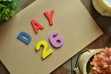 Aufkleber - Day 26, cover design in natural concept with the alphabet on brown notebook on the wooden table for a background.